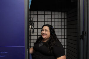 Maria engaged in a medical voiceover session in her booth
