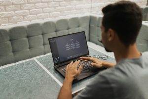 conversational ai voice actor performance from a laptop with a user typing at a table